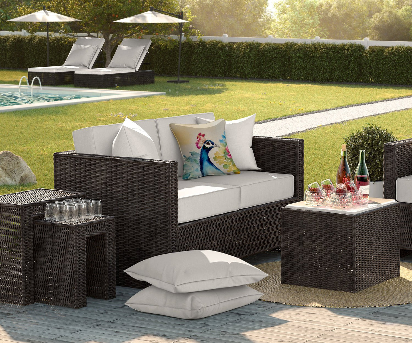 Carolines Treasures peacock throw pillow on outdoor rattan sofa with white cushions by pool