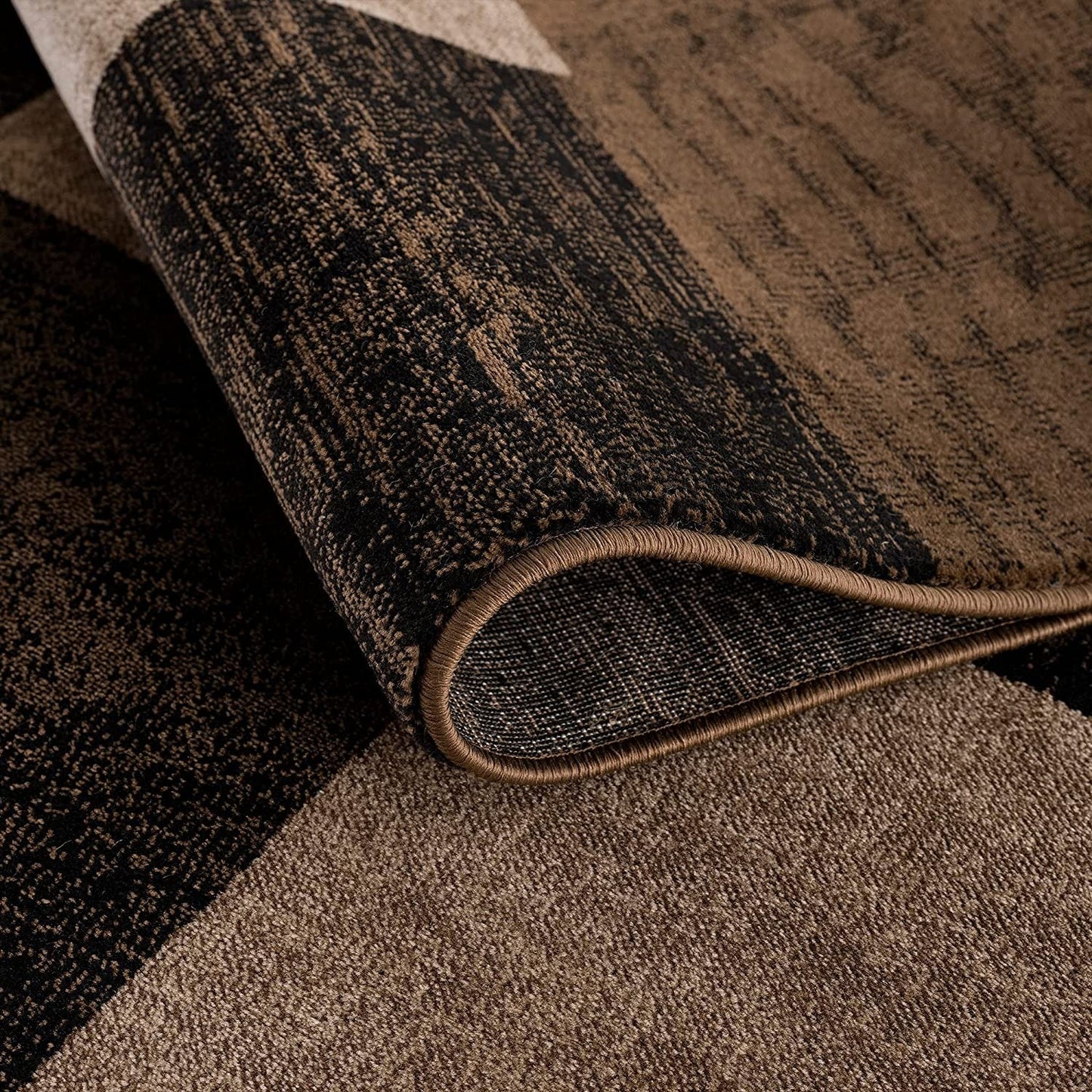 Homeroots geometric shag runner rug close up folded corner showing brown and black geometric pattern and plush pile