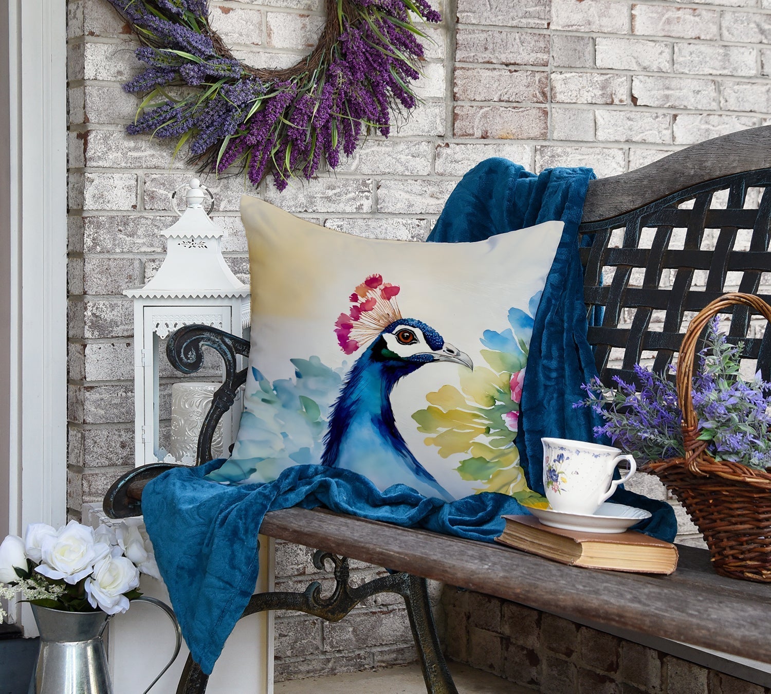 Carolines Treasures peacock throw pillow watercolor peacock design on outdoor bench with blue throw and teacup