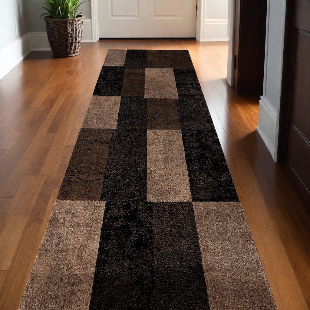 Homeroots geometric shag runner rug in brown and black block pattern on hardwood hallway floor