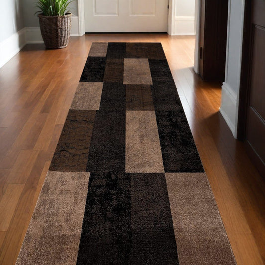 Homeroots geometric shag runner rug in brown and black block pattern on hardwood hallway floor