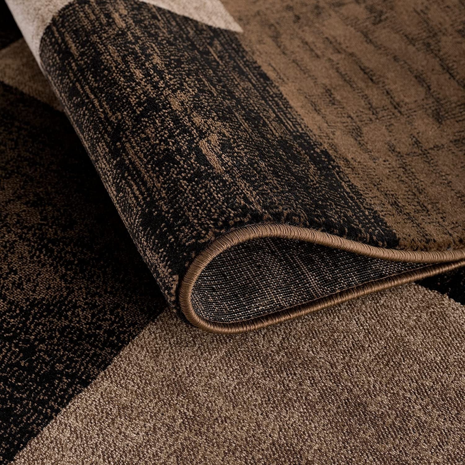 Homeroots geometric shag runner rug close up folded corner showing brown and black geometric pattern and plush pile