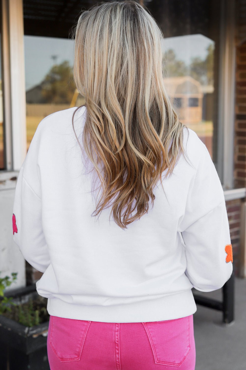 Threaded Pear Howdy patch sweatshirt back view on model wearing white sweatshirt with floral elbow patches